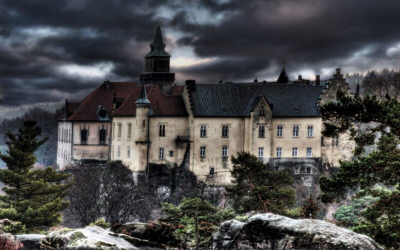 Castle on a cliff under stormy sky