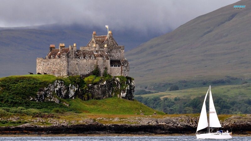 Castle on a cliff with sailboat