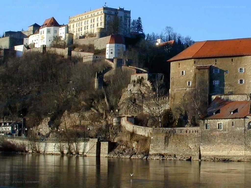 castle on a hill by the river