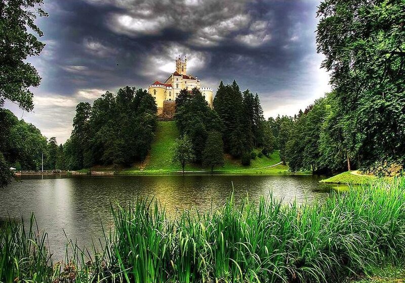 Castle on a Hill — Green, Dramatic, Afternoon, Photograph, Lake, Trees, Clouds