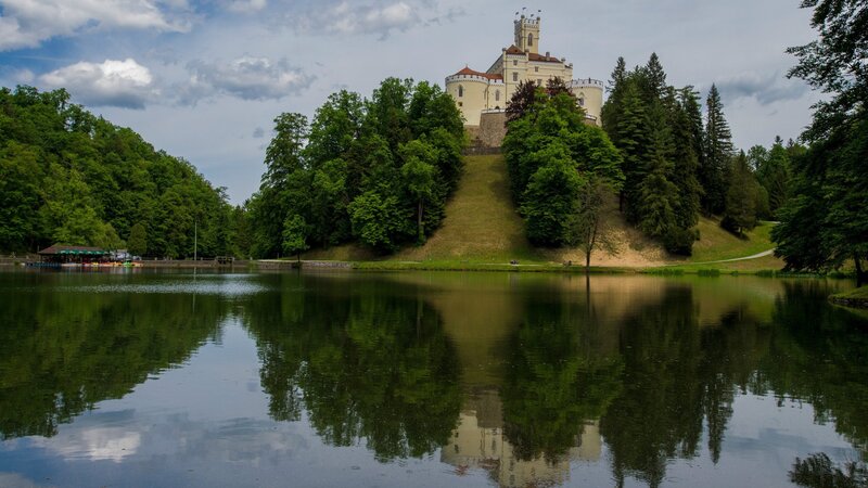Castle on a Hill — Green, Serene, Afternoon, Photograph, Lake, Trees, Sky