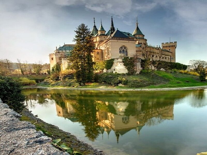 Castle on a Hill — Green, Serene, Afternoon, Photograph, River, Trees, Sky