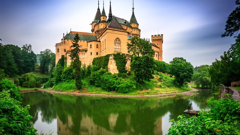 Castle on a Hill — Green, Serene, Afternoon, Photograph, River, Trees, Towers
