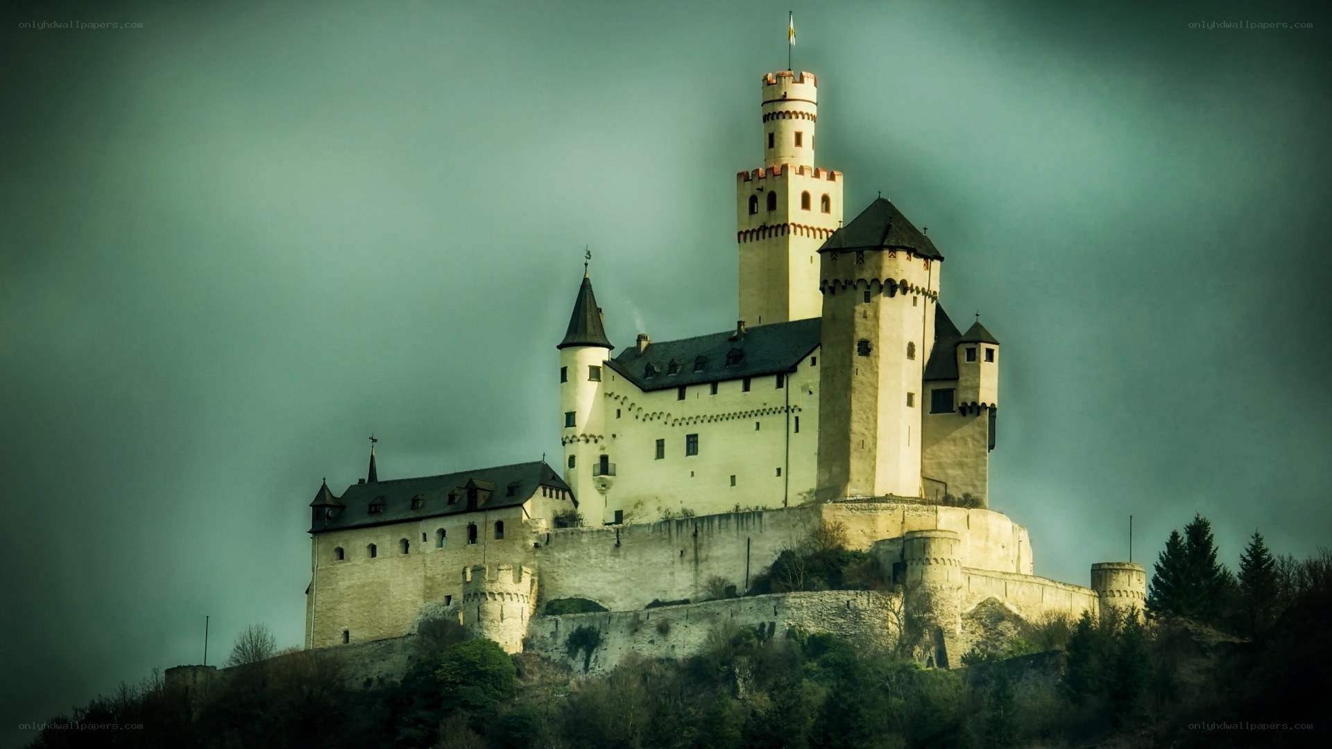 Castle on a hill under cloudy sky