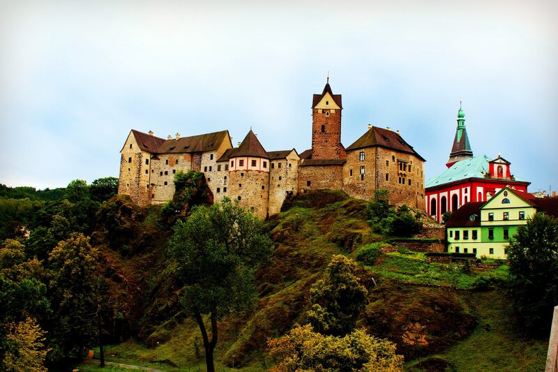 castle on a hill with colorful buildings