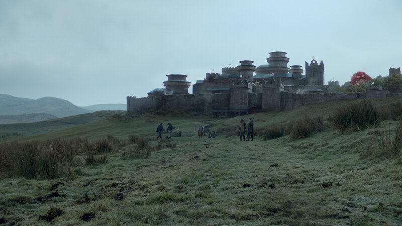 castle on a hill with travelers