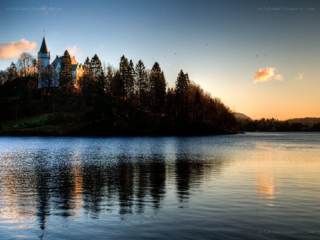 castle on a lake at sunset