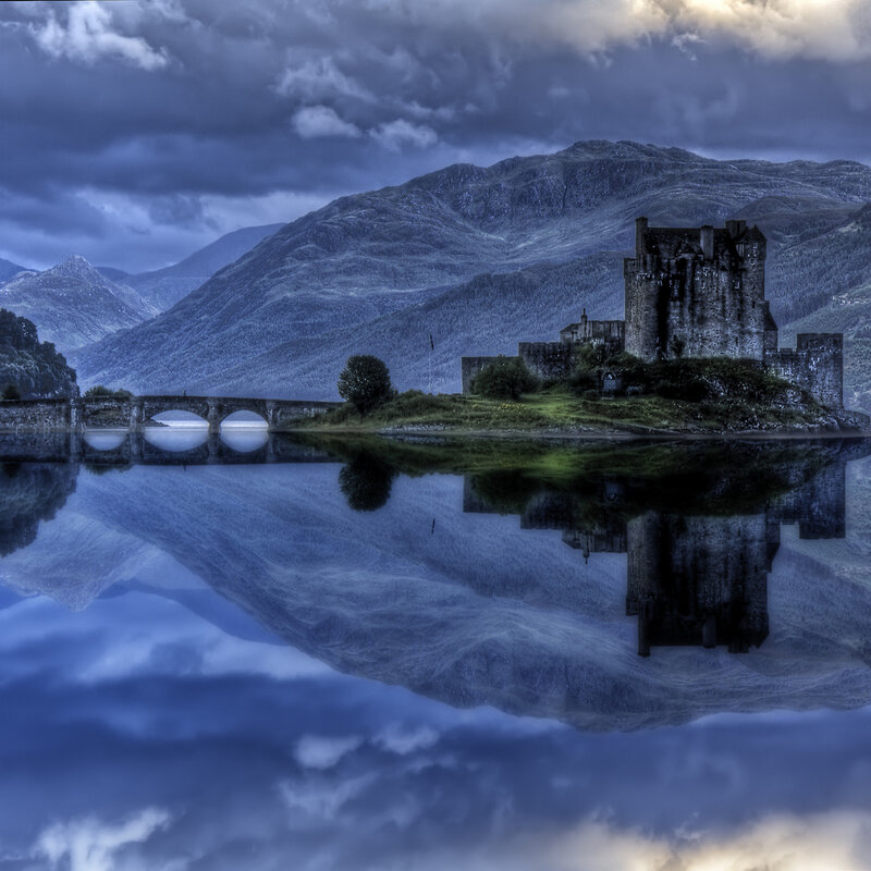 Castle on a lake with mountains