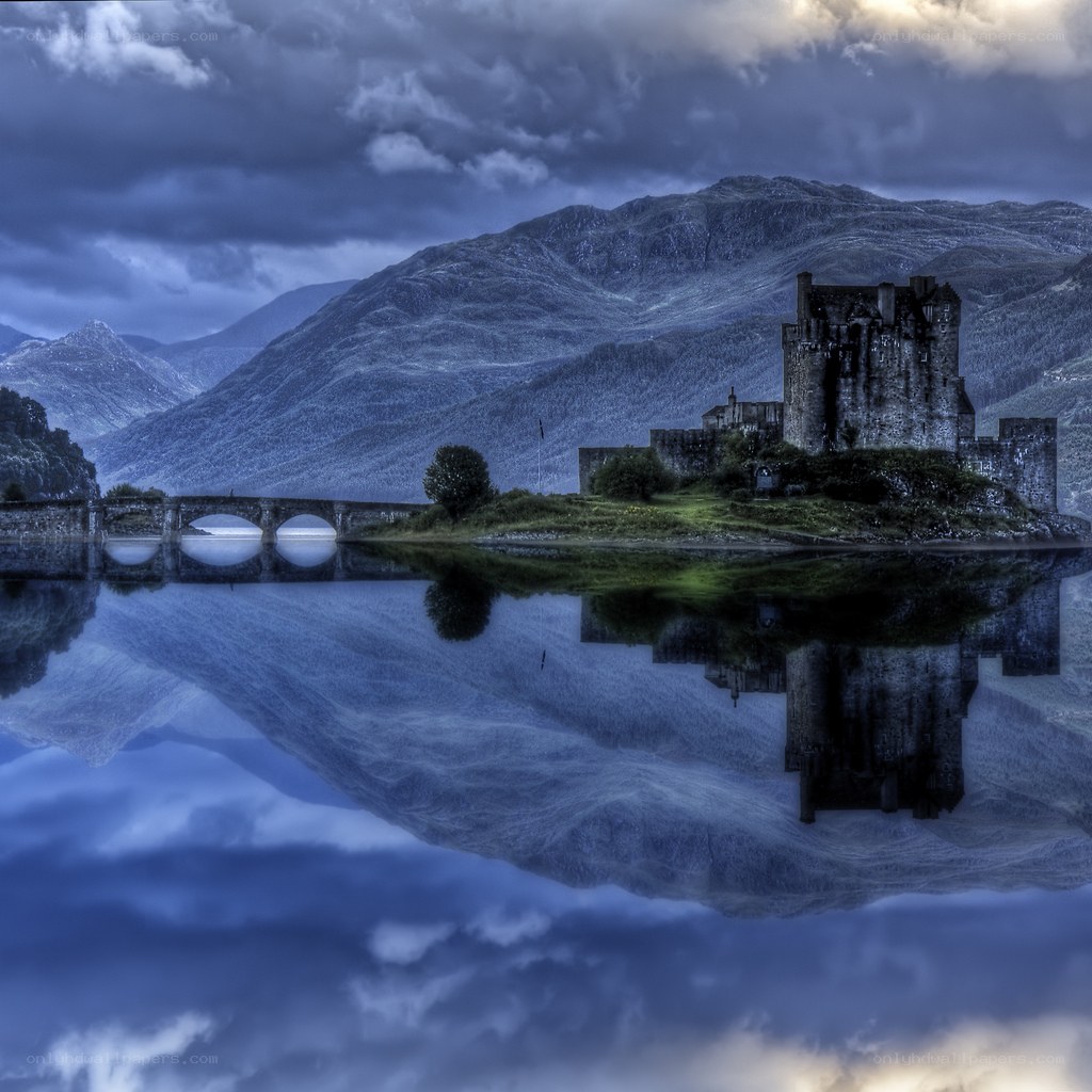 Castle on a lake with mountains