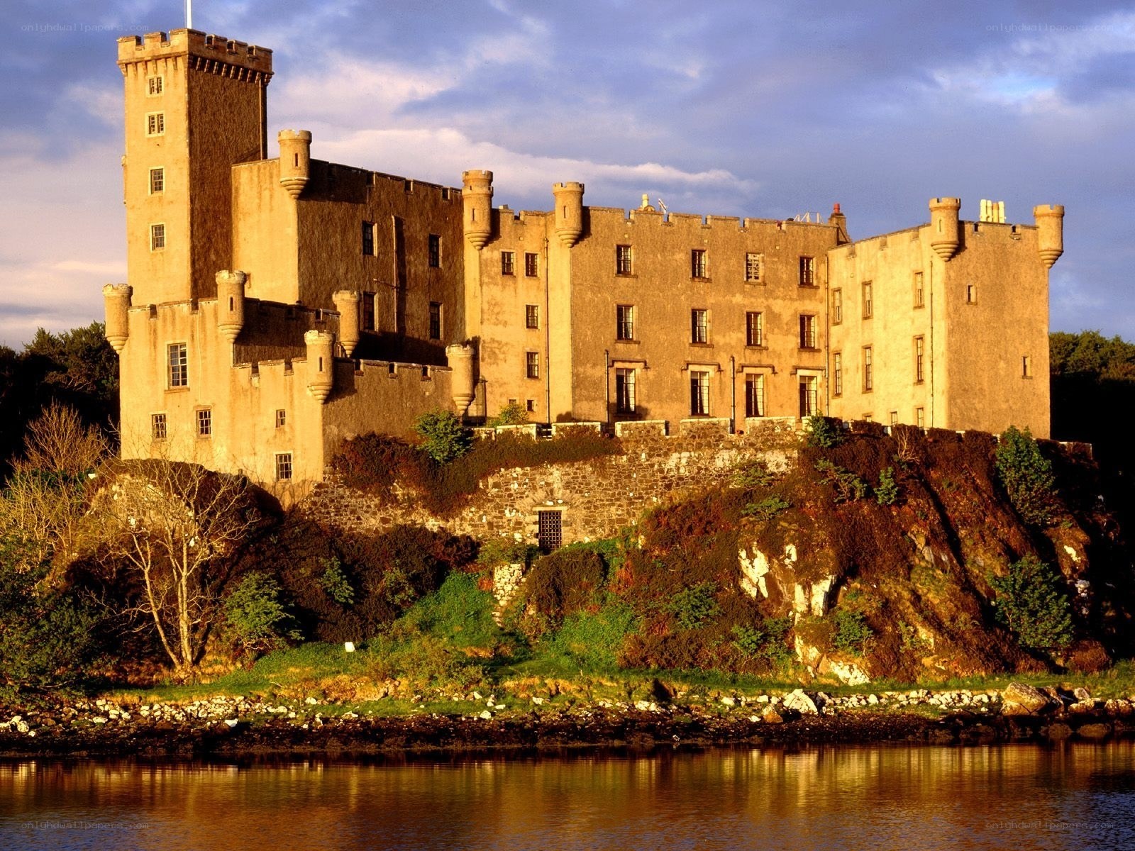 Castle on a riverbank at sunset