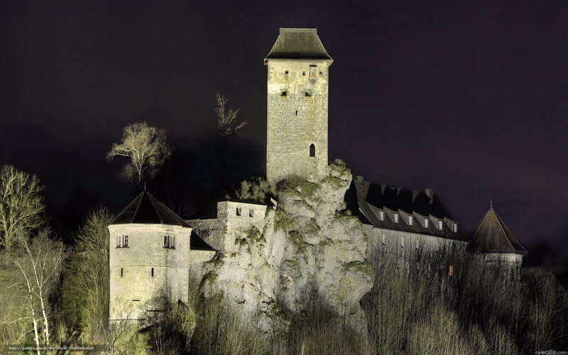 Castle on a rocky cliff at night