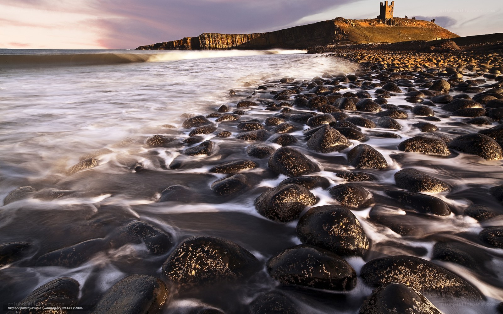 Castle on a rocky coast at sunset