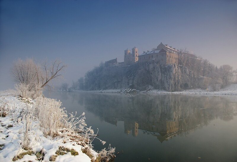Castle on a snowy riverbank