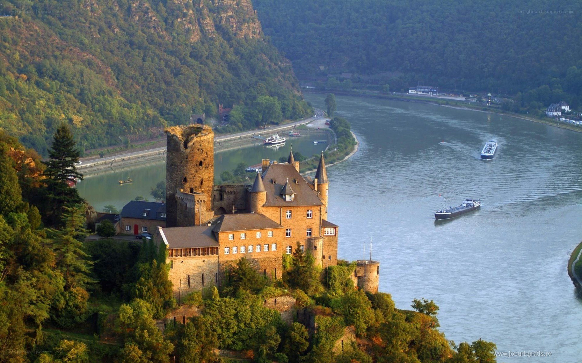 Castle on riverbank with boats