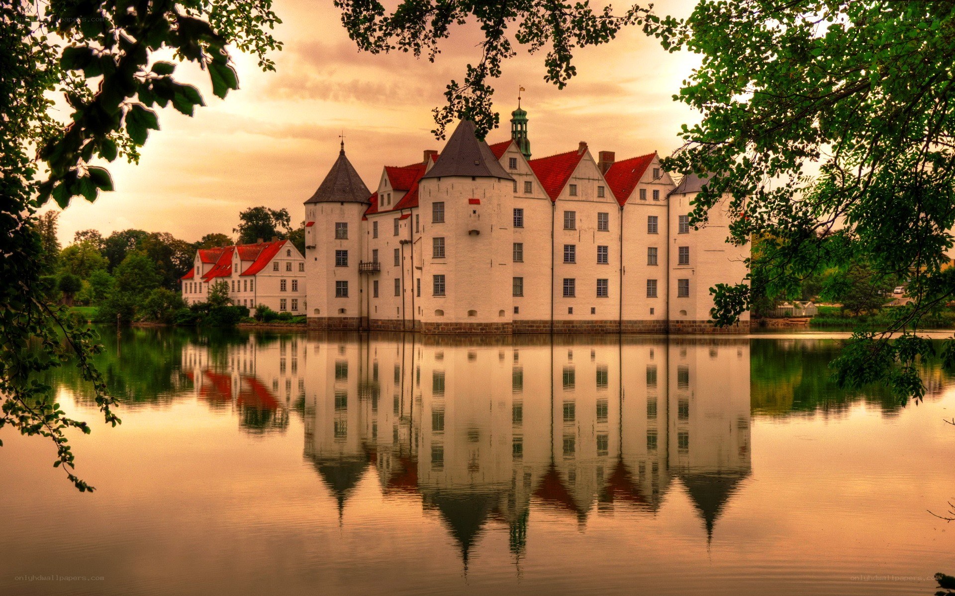 Castle reflected in a lake at sunset