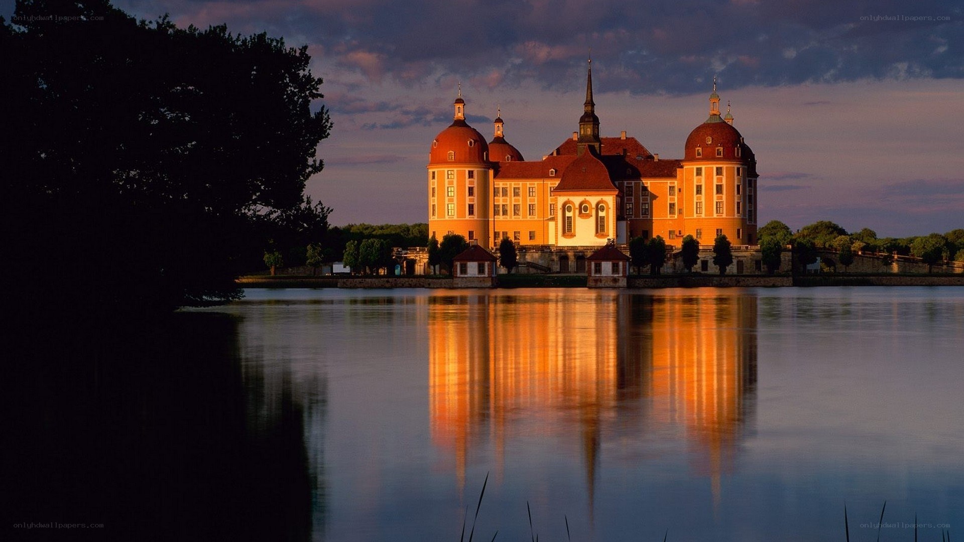 castle reflected in lake at dusk