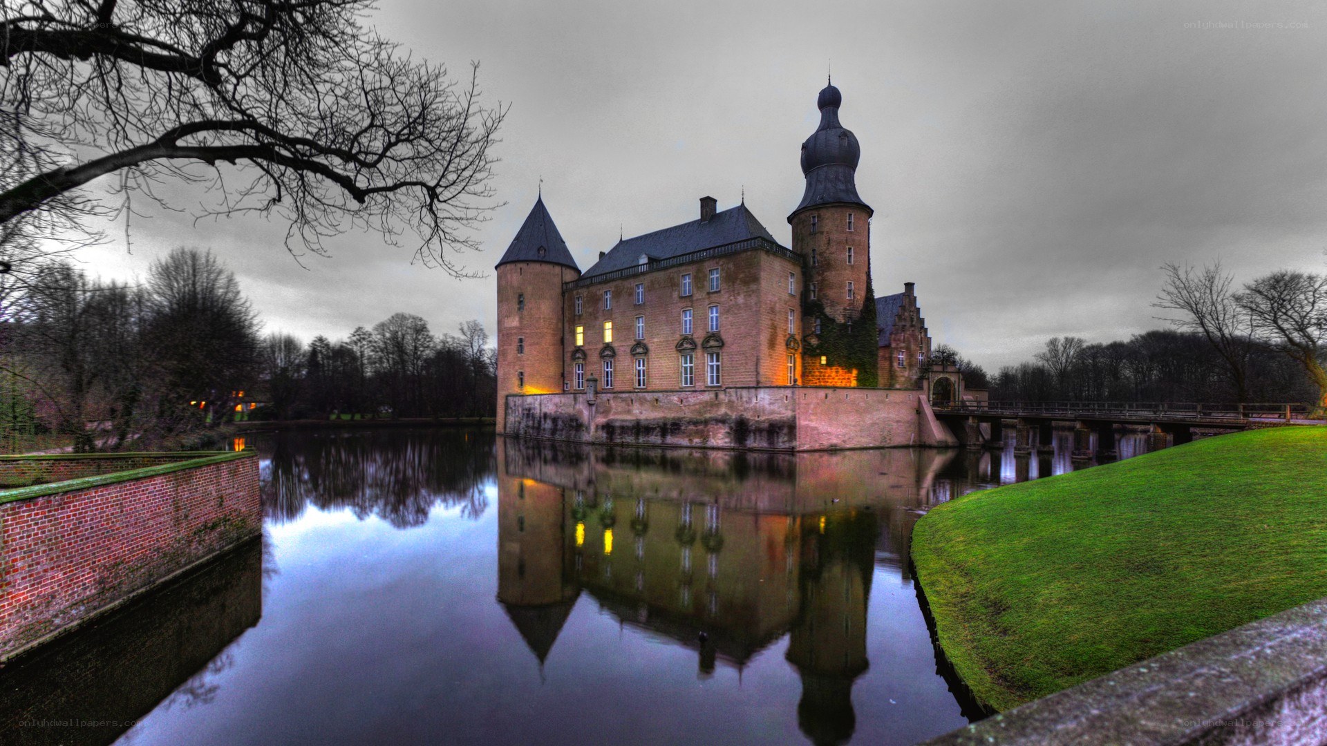 castle reflected in moat at dusk