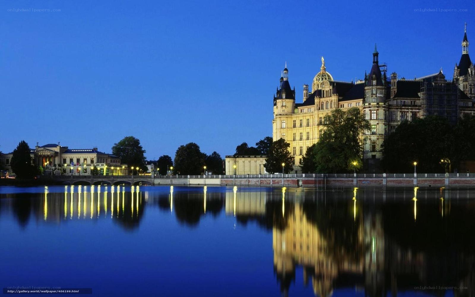 castle reflected in river at dusk