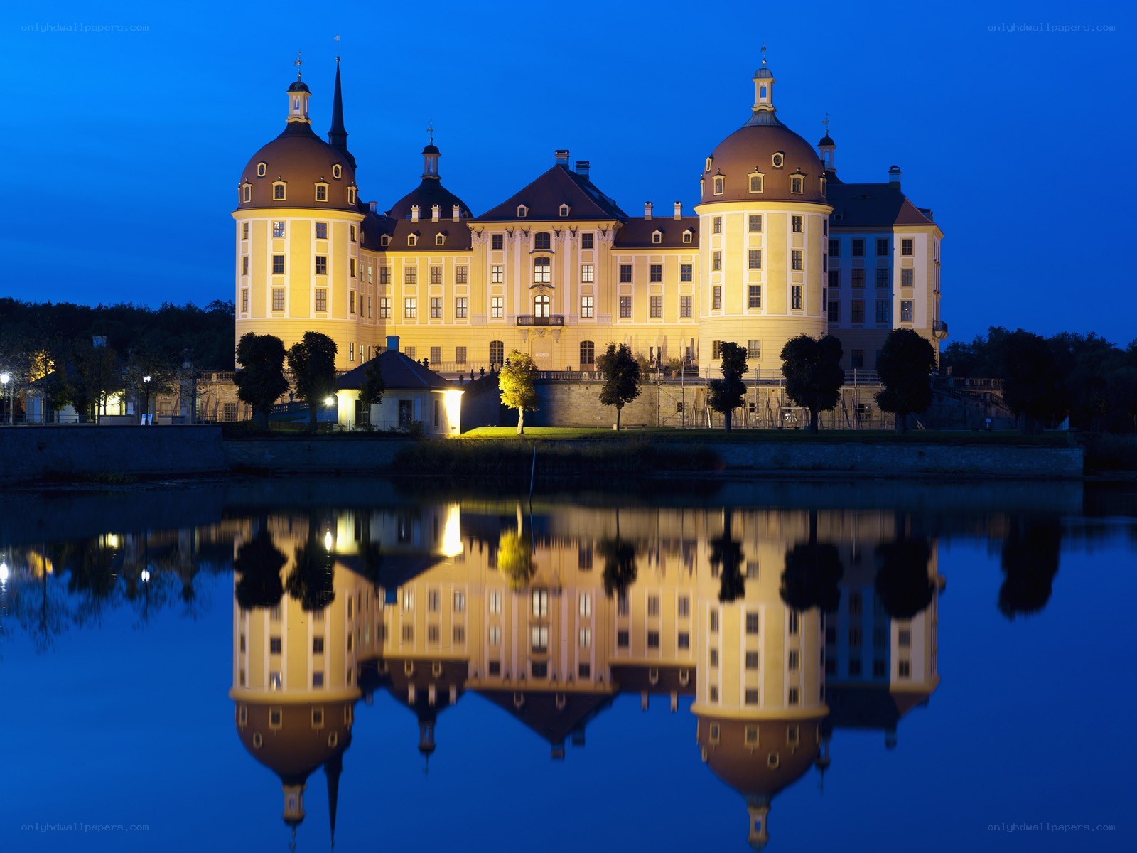 castle reflected in water at dusk