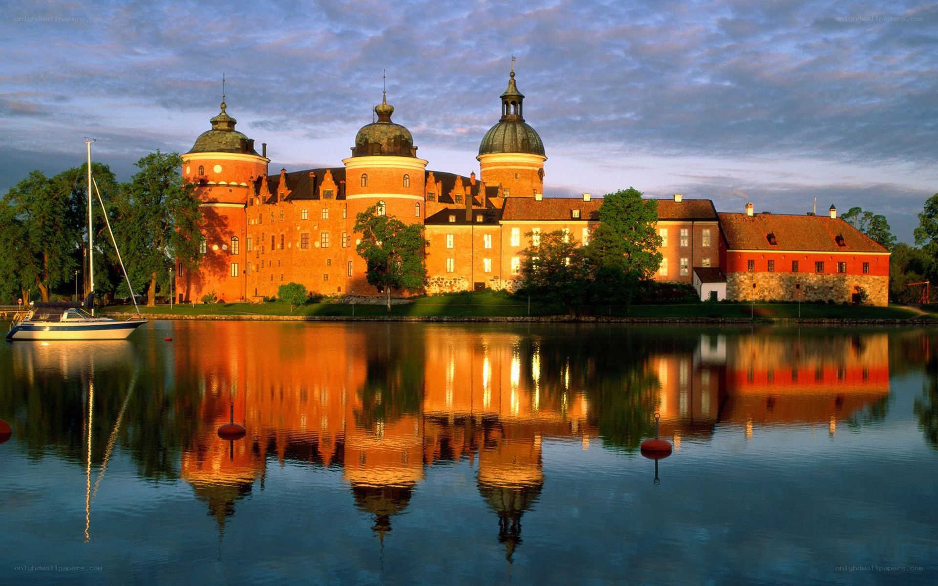 castle reflected in water at dusk