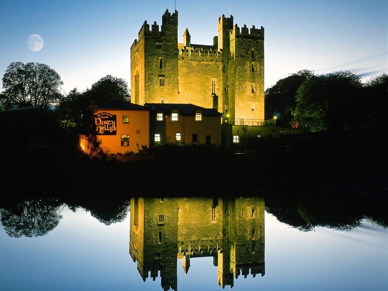 Castle reflected in water at night