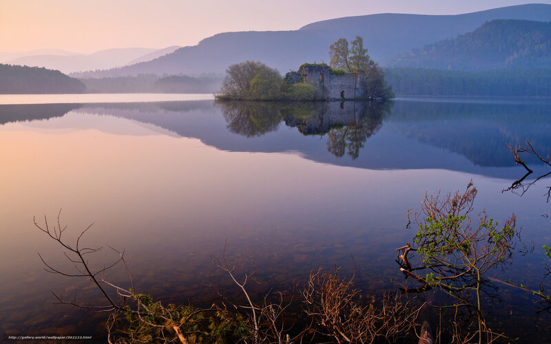 Castle ruin on a lake at dawn