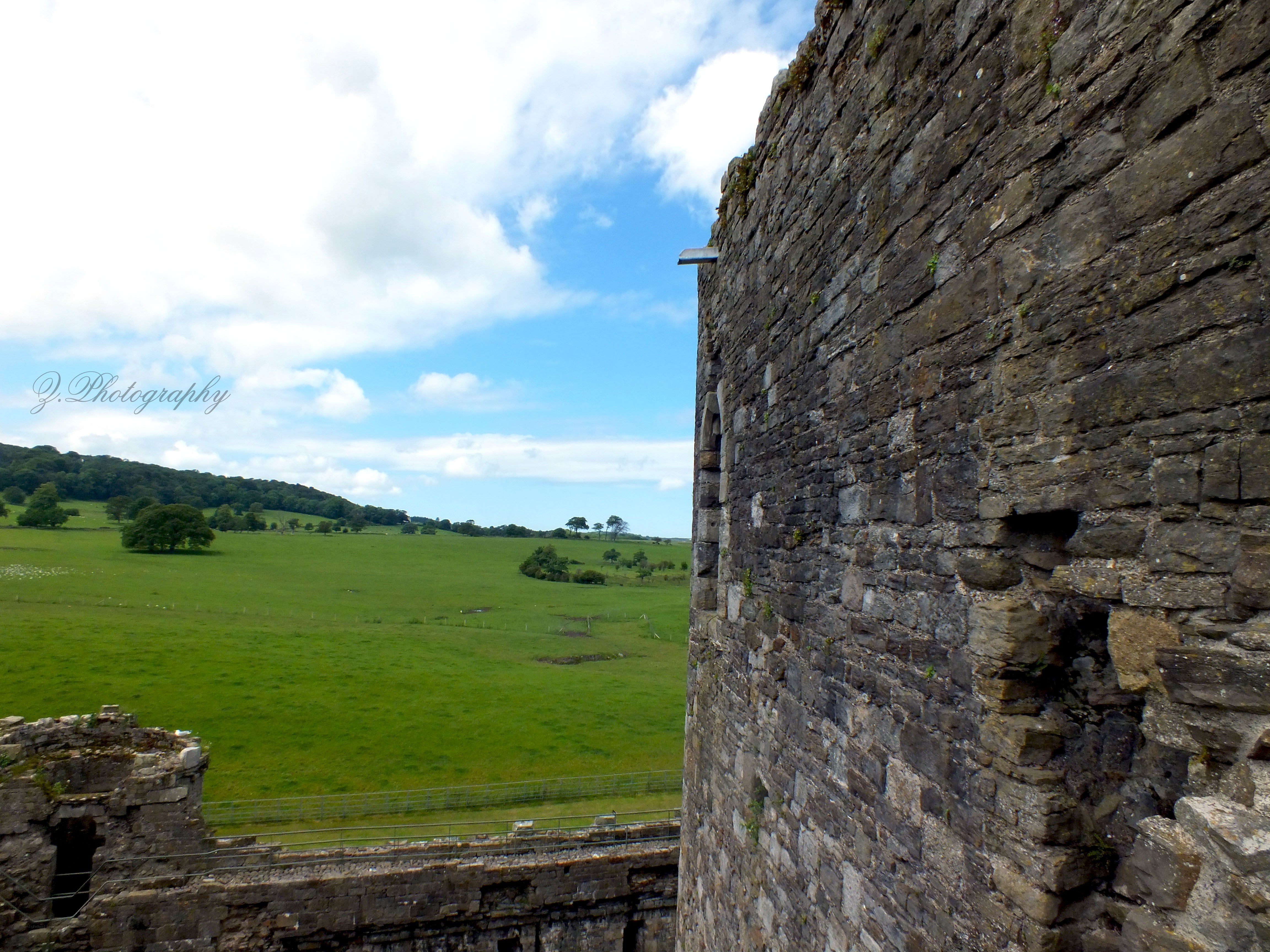 Castle ruins overlook green fields
