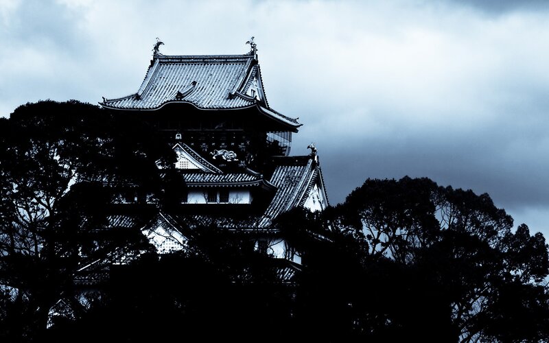 Castle silhouette under stormy sky