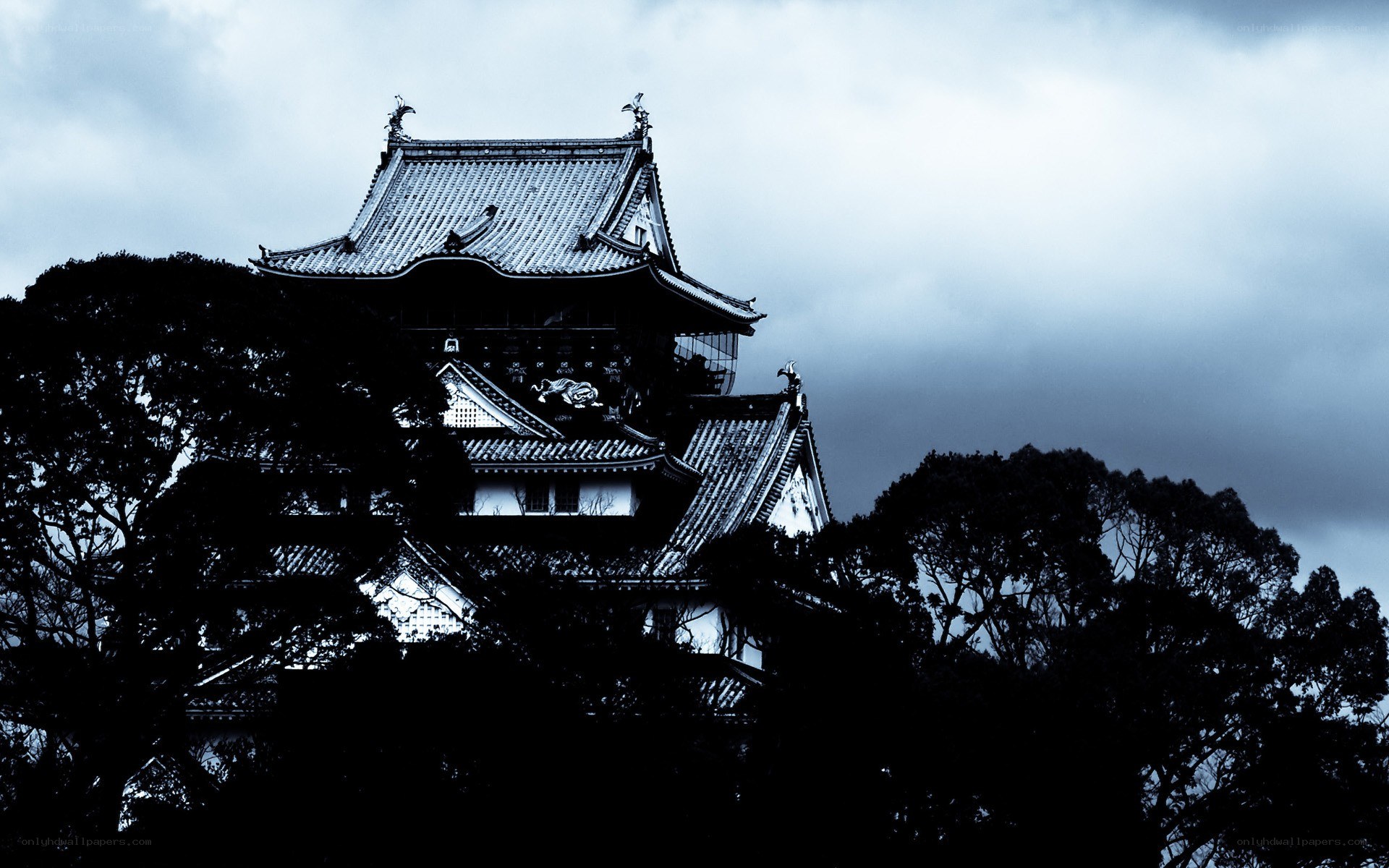 Castle silhouette under stormy sky