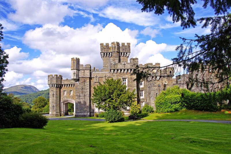 Castle with green lawn and blue sky