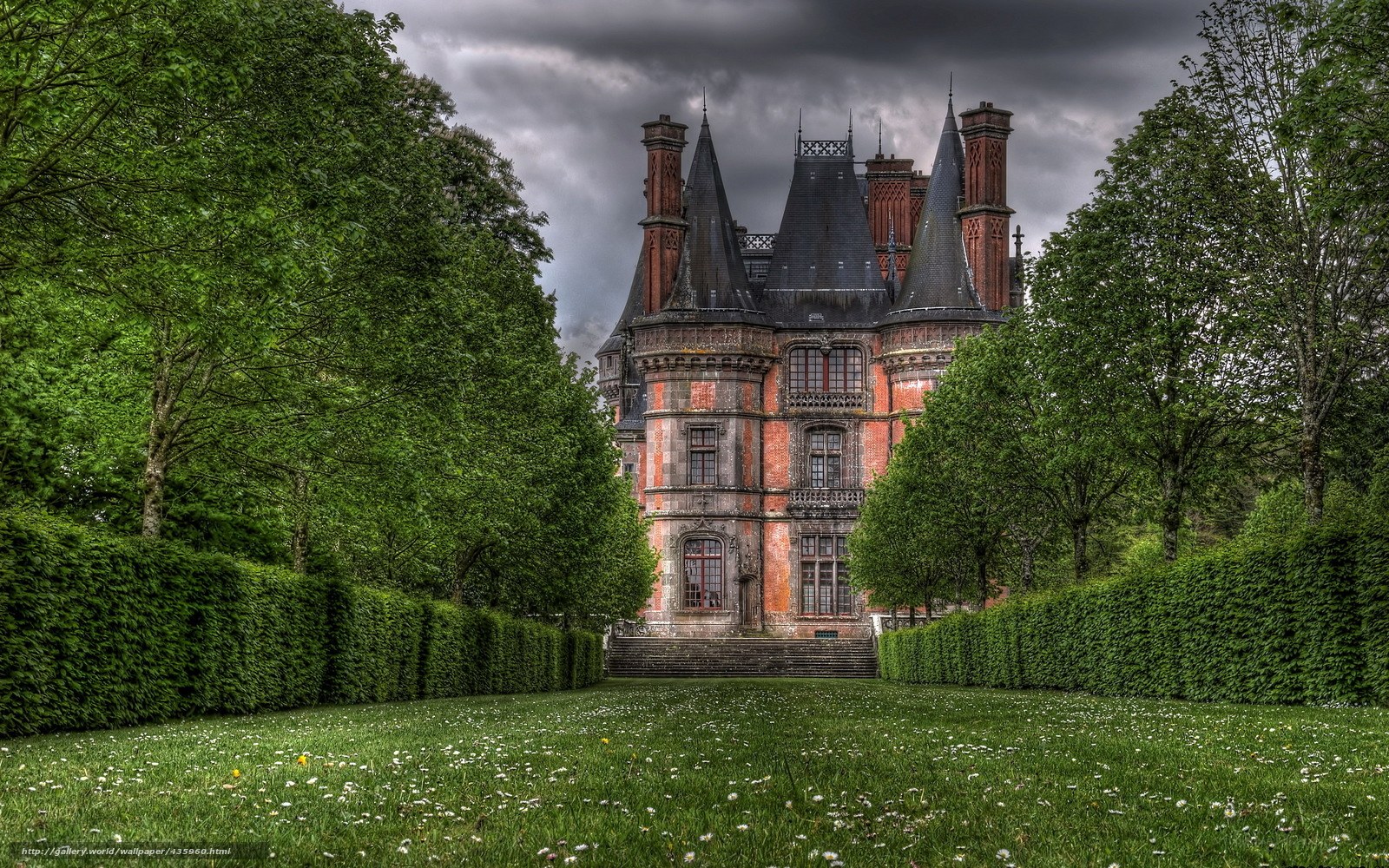 Castle with green lawn and trees
