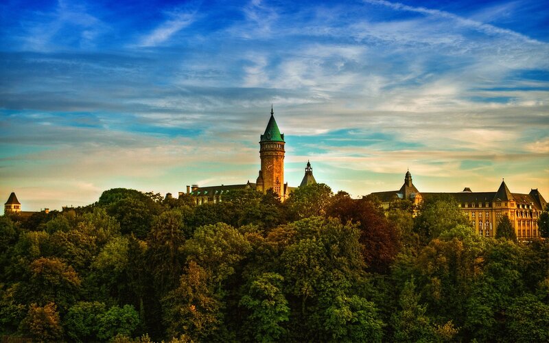 castle with green roof at sunset
