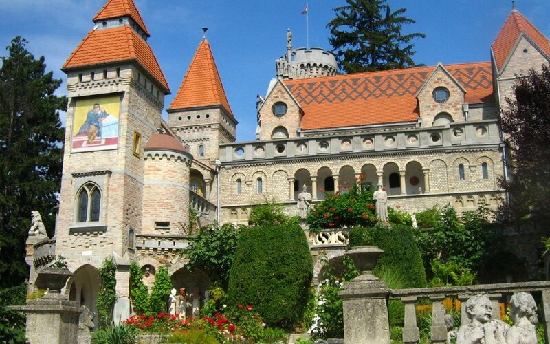 castle with red roof and gardens