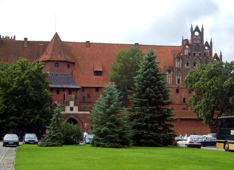 Castle with red roof and green trees