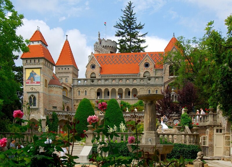castle with red roofs and gardens