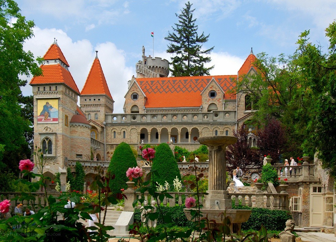 castle with red roofs and gardens
