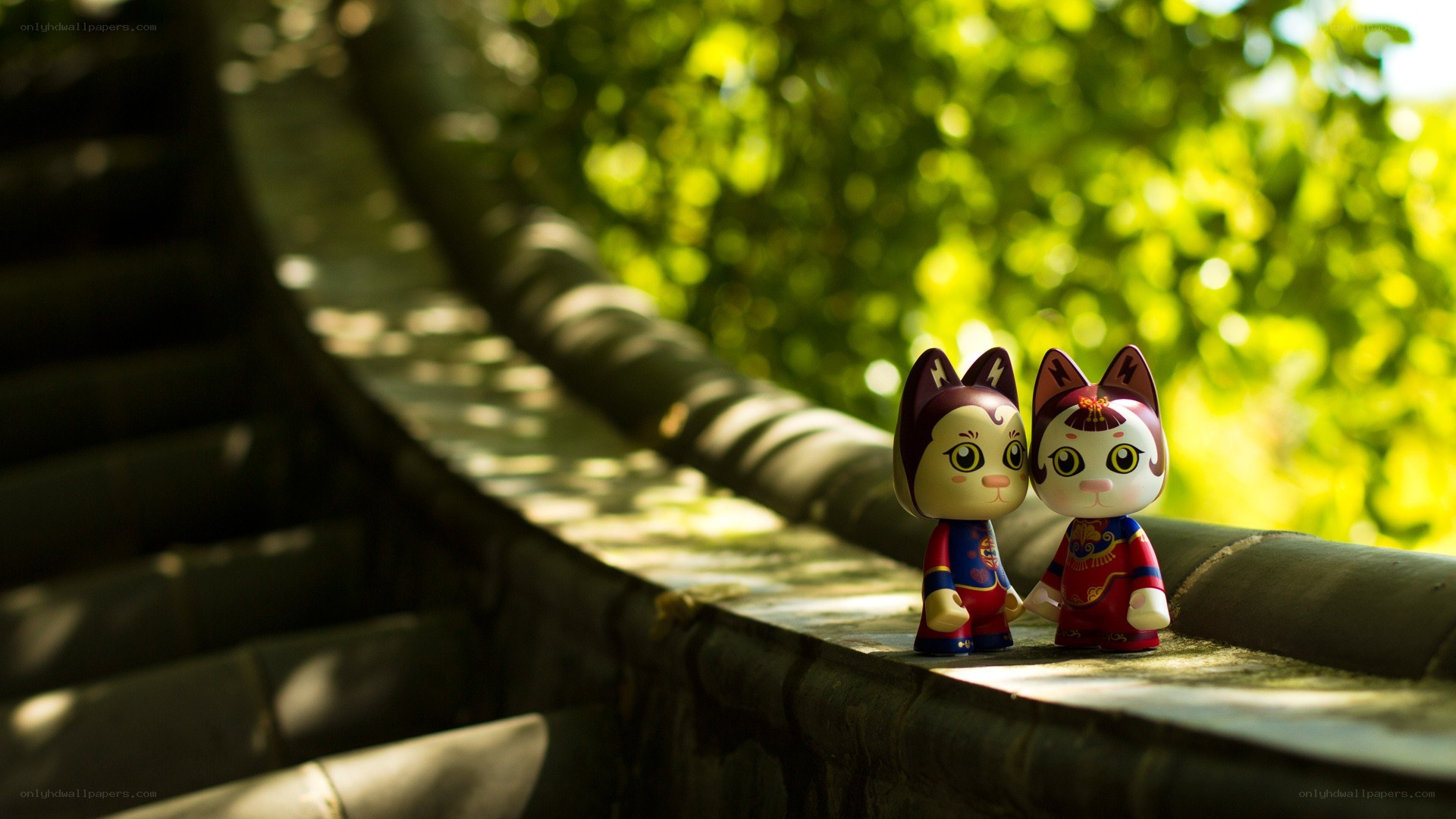 Cat figurines on a stone wall