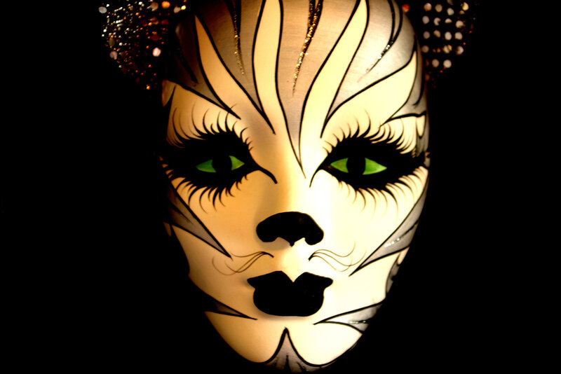 cat-themed mask with green eyes