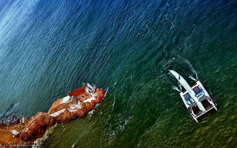 Catamaran Near Lighthouse — Blue