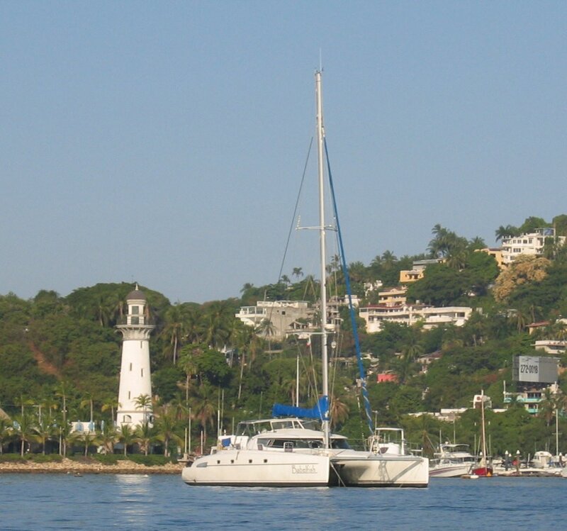 Catamaran near lighthouse