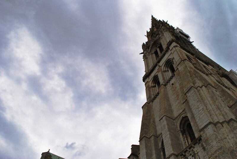 Cathedral tower against cloudy sky