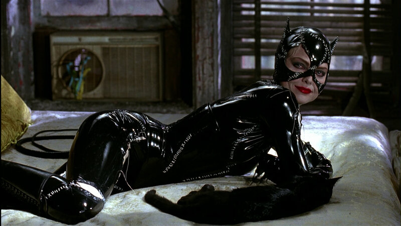 Catwoman on a bed with cat