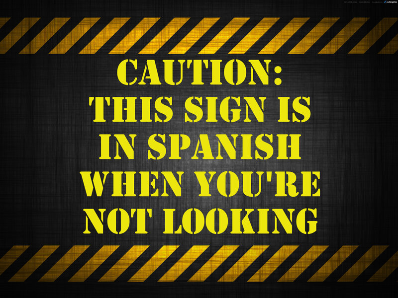 Caution sign in Spanish