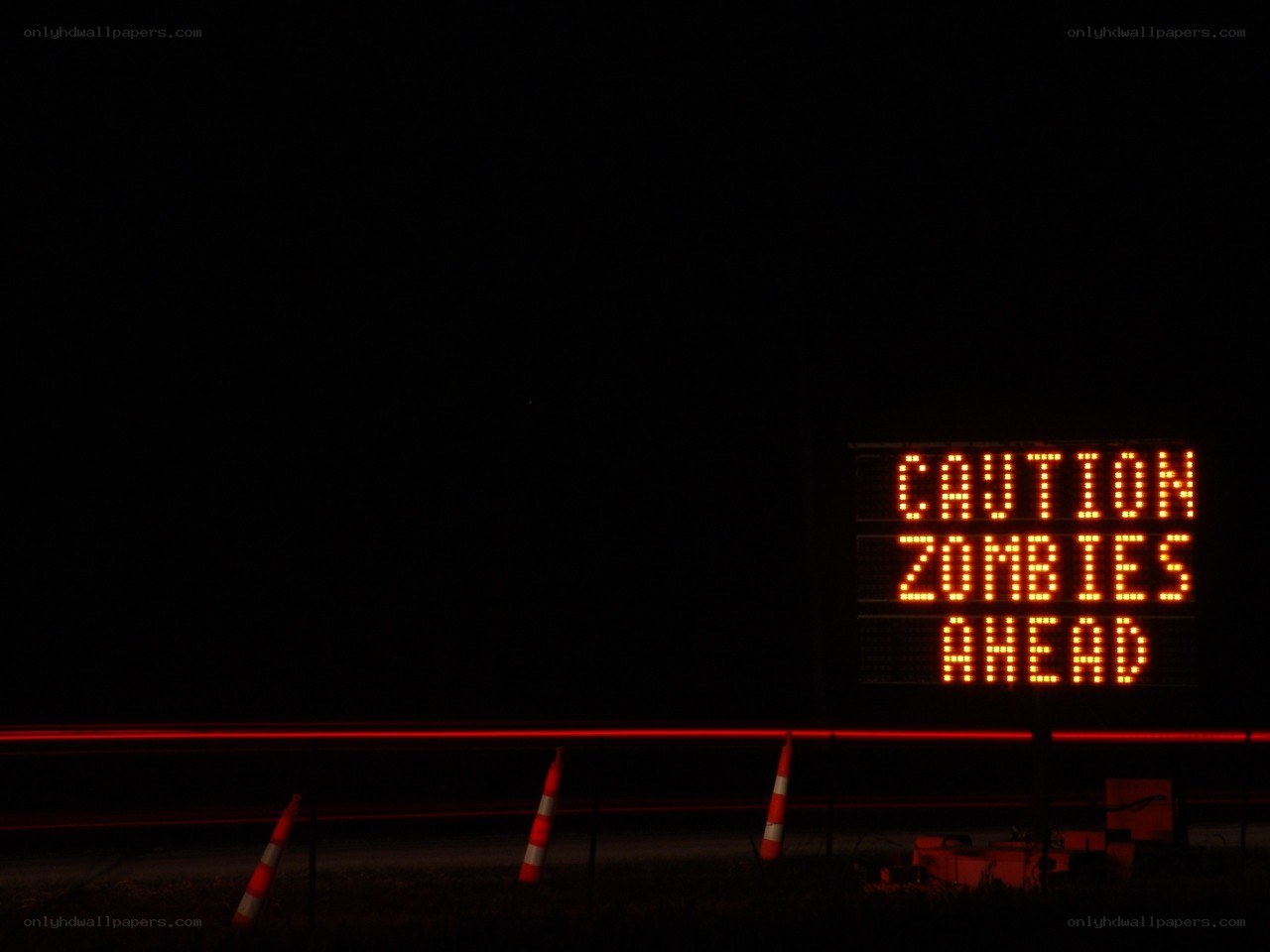 Caution: Zombies Ahead sign at night