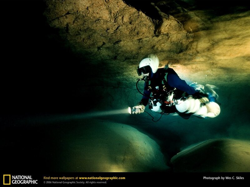 Cave diver exploring underwater passage