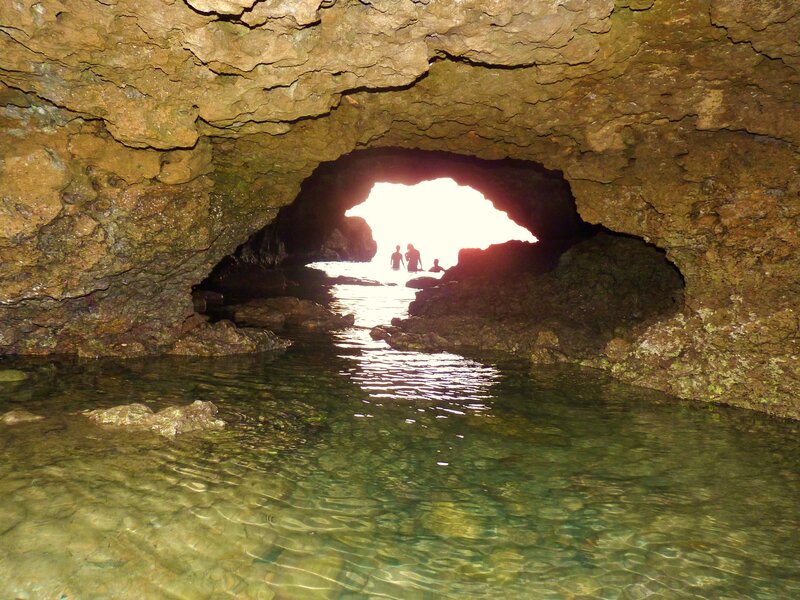 Cave entrance with people at the shore