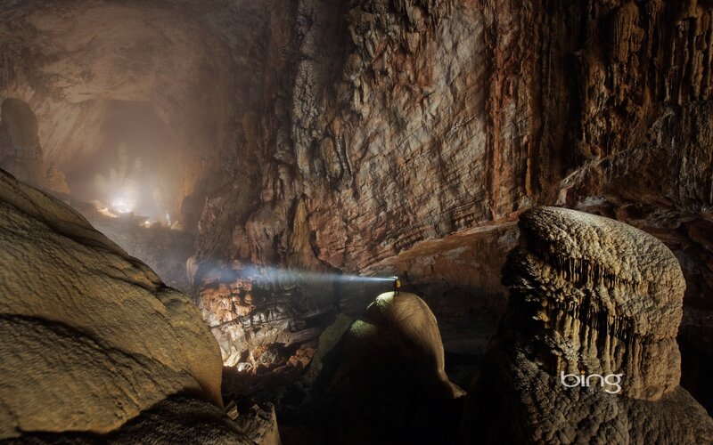 Cave explorer with flashlight