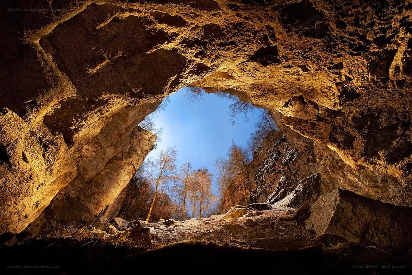 Cave opening to blue sky