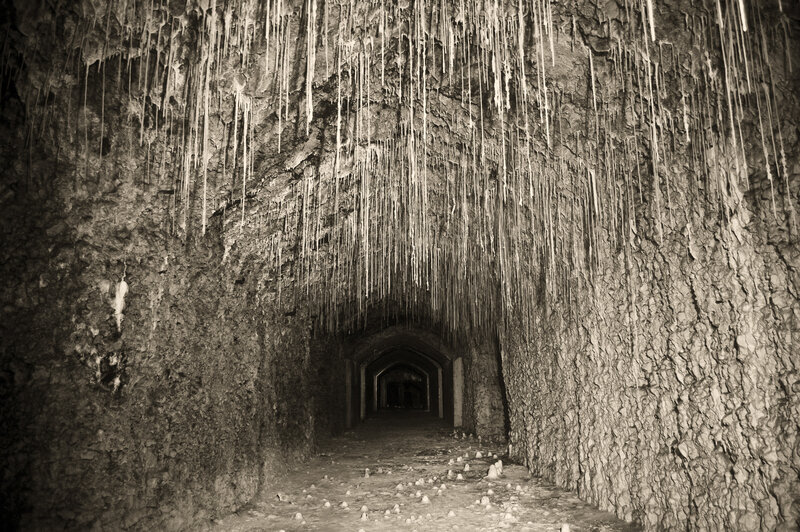 cave tunnel with stalactites
