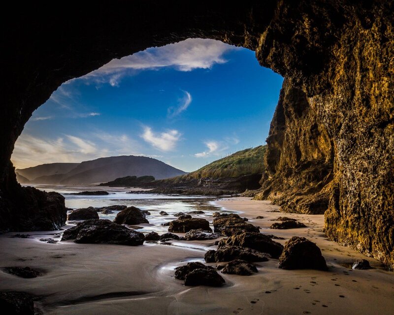 Cave view of beach and mountains